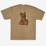Mushroom brown t-shirt with graphic of an artistically painted battered teddy bear with yellow and red paint splatter.