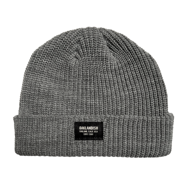 Short cuffed beanie, ribbed knit in athletic heather grey, with Oaklandish square patch on the front cuff.