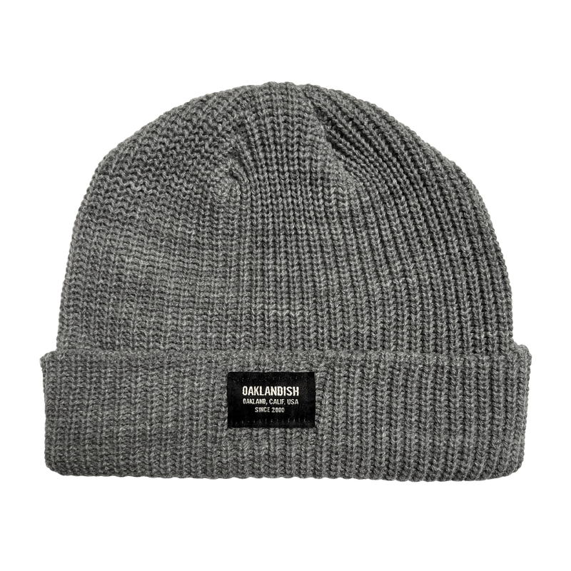 Short cuffed beanie, ribbed knit in athletic heather grey, with Oaklandish square patch on the front cuff.