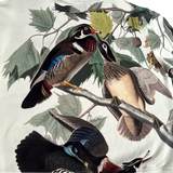 Close up of back side of all over wood duck print cream on crewneck Oaklandish sweatshirt.