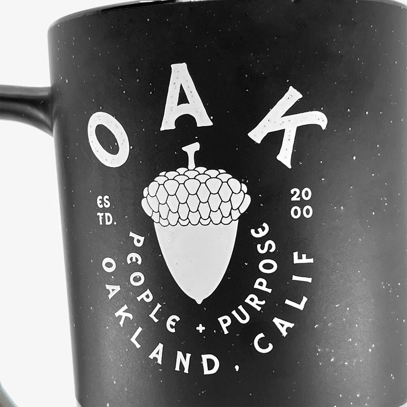 Close up of the graphic saying “OAK People, Purpose, Oakland Calif” on the stoneware mug.