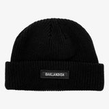 Black shorter style cuff beanie with white Oaklandish wordmark on cuff patch.