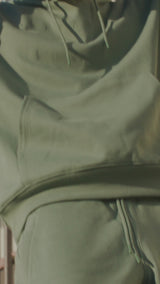 Male and female model on campus wearing the fleece sets, male in Army and female in Sand.