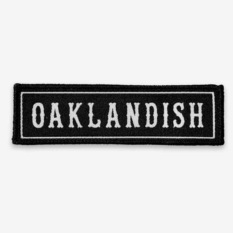 Rectangular black iron-on biker’s patch with white Oaklandish wordmark and white trim.