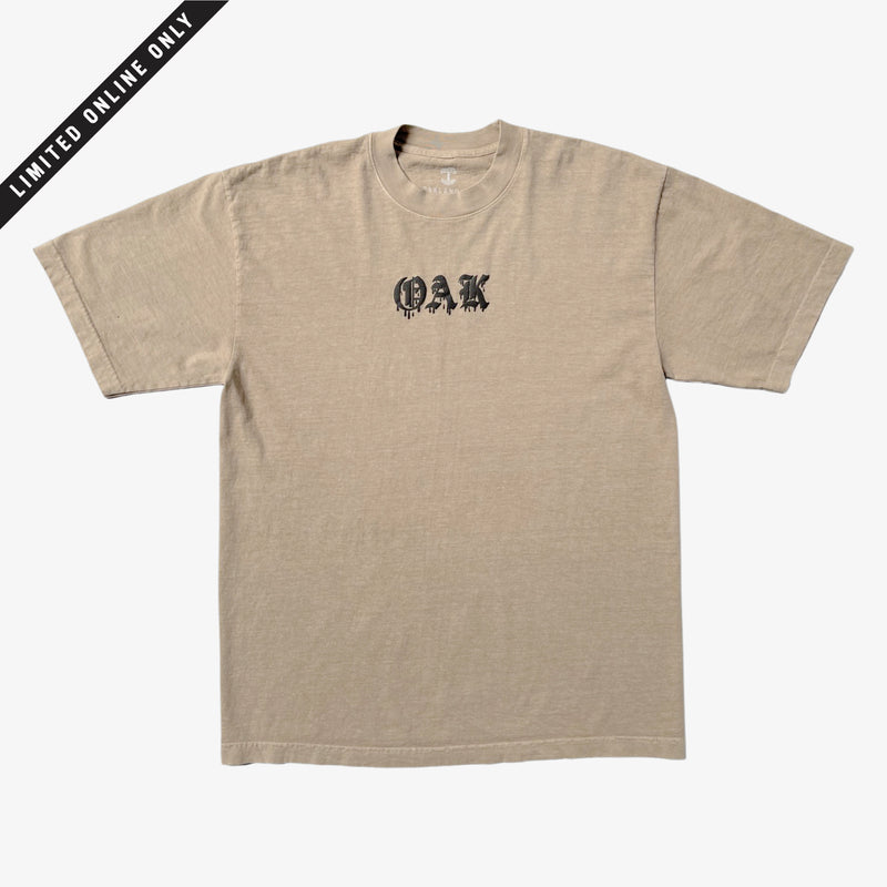 Mushroom brown t-shirt with black OAK wordmark in old style font with a bleed. 