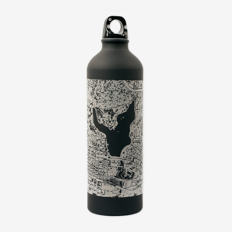 A black water bottle imprinted with an aerial view of a map of Oakland and threaded screw on top with a finger ring.