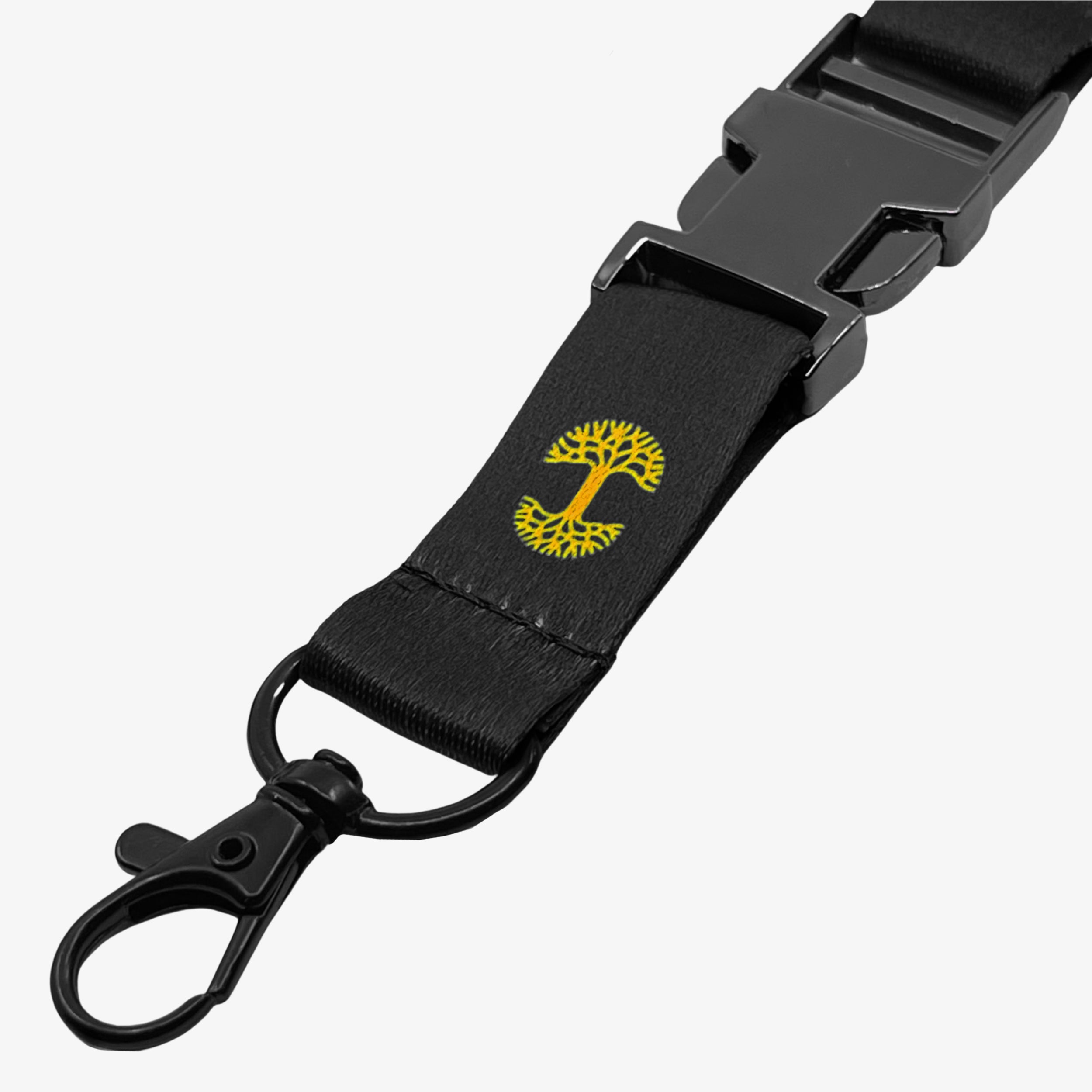 Close up detachable clip with yellow Oakandish tree logo on a black lanyard.