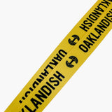Close up of black Oaklandish word mark and tree logo on a yellow lanyard.