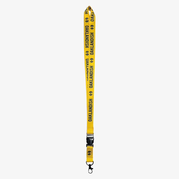 Yellow lanyard with black Oaklandish word mark and tree logos on repeat with a detachable clip with Oaklandish tree logo.