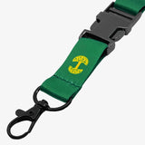 Close up detachable clip with yellow Oakandish tree logo on a green lanyard.