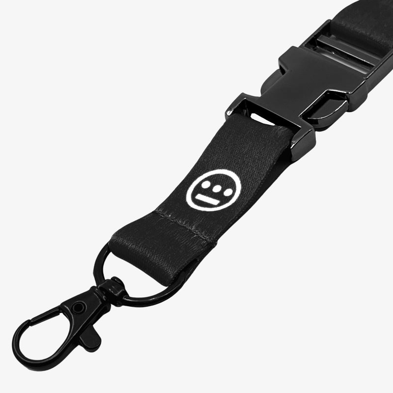 Close-up of quick release clasp on a black lanyard with white Hiero hip-hop logo.