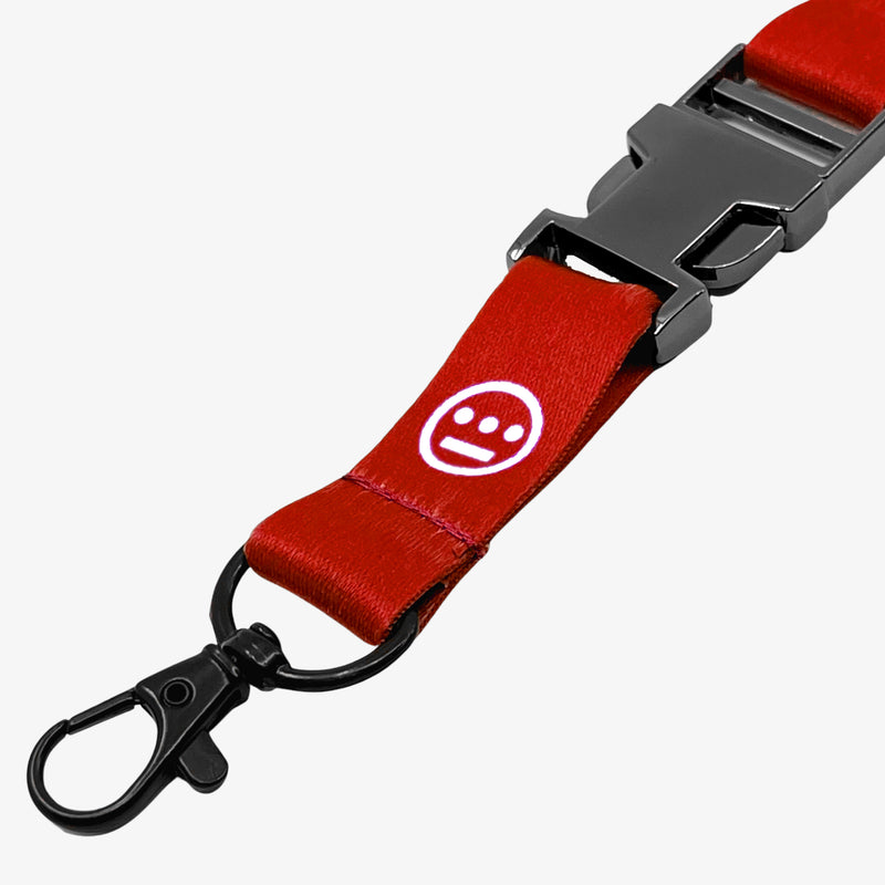 Close-up of quick release clasp on a red lanyard with white Hiero hip-hop logo.