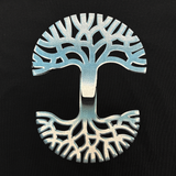 Detailed close up image of Oaklandish classic tree logo with a chromed out graphic effect on a black t-shirt.