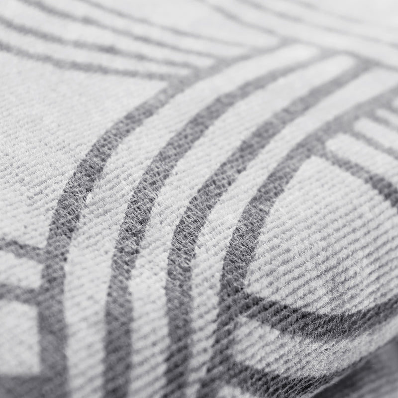 Very detailed close up of Oaklandish logo outline on an oversized silver-grey beach towel.