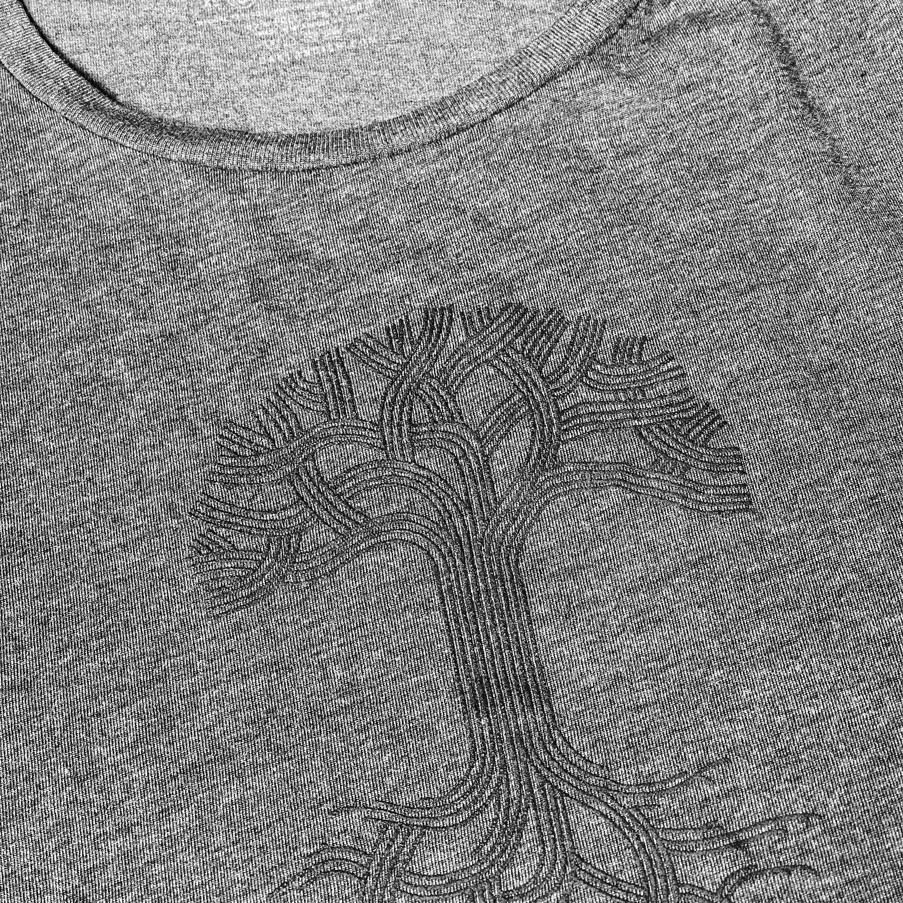 Close-up black classic Oaklandish tree logo and wordmark on chest of a grey women’s cut tank top.
