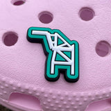 Close up of shoe charm with an Oakland crane outlined in white on a green background on a pink croc.
