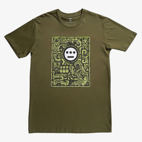 Black and white Hieroglyphics hip hop logo on a carved gravestone on an army green t-shirt.