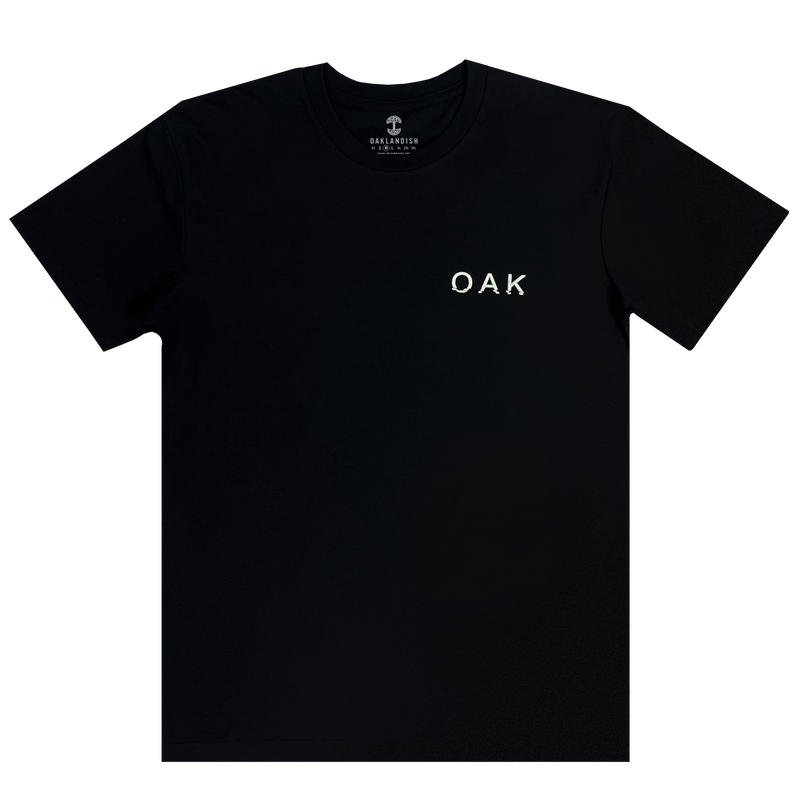Front view of a black t-shirt with OAK wordmark on the right chest in white puff ink print.