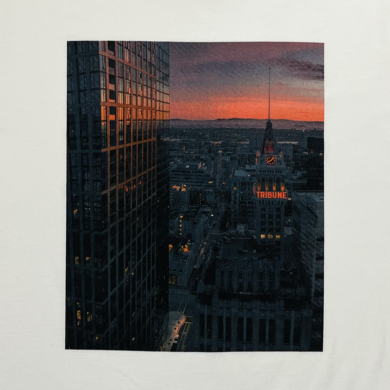 Close up image of natural colored t-shirt with Vincent James photography image of the Oakland Tribune building and the Downtown Oakland landscape.