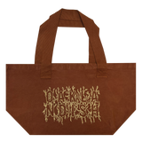 Front view of Ginger shopping tote with creme ink and Oaklandish wordmark surrounded by stems and vines. 