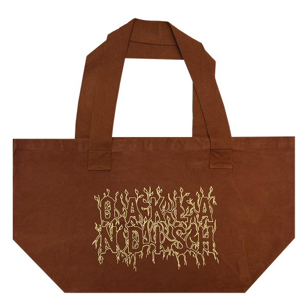 Front view of Ginger shopping tote with creme ink and Oaklandish wordmark surrounded by stems and vines. 