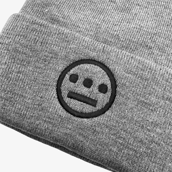 Close-up of embroidered black Hieroglyphics hip hop logo on front cuff of a gray cuffed beanie.