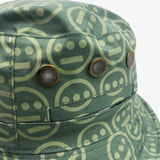 Close-up of vents on the green side of a reversible bucket hat with light green Hieroglyphics hip-hop logo on repeat. 