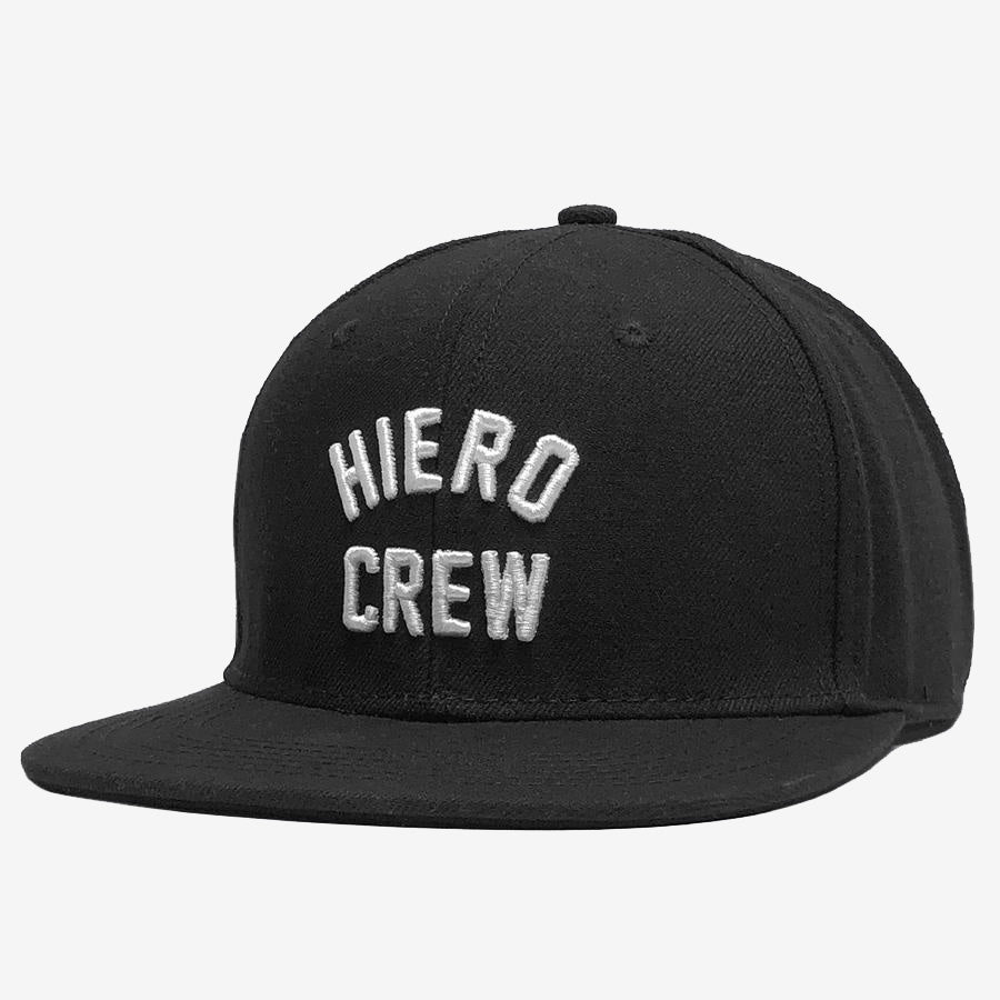 A black Hiero Crew Snapback baseball cap from Hieroglyphics featuring a flat brim. The front showcases the words "HIERO CREW" in white, embroidered capital letters. The headwear is set against a plain white background, accentuating its simple and clean design.