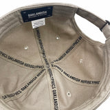 Inside of khaki dad cap crown with ‘OAKLANDISH’ wordmark on black striping and Oaklandish patch.