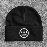 Black cuffed beanie with embroidered white Hieroglyphics logo on the cuff on asphalt.