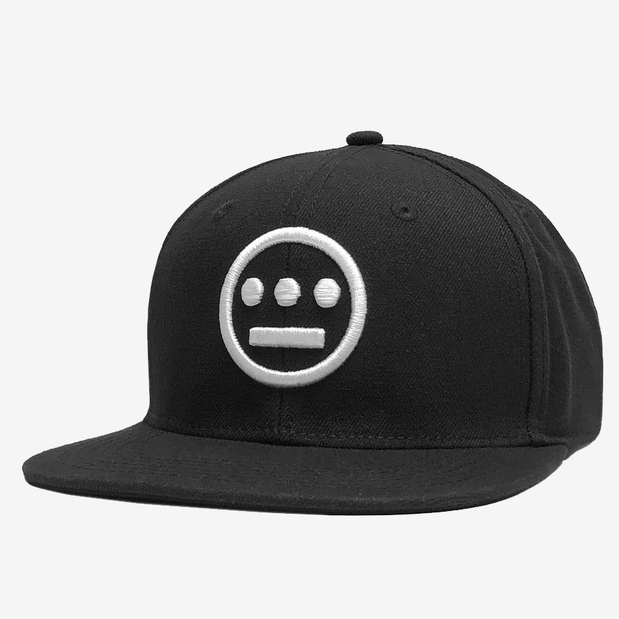 The Hieroglyphics Hiero Logo Snapback is a black snapback hat featuring a white embroidered hieroglyphic symbol on the front. The emblem consists of a circle with three dots arranged horizontally in the upper half and a horizontal line beneath them within the circle. This unique headwear boasts a flat brim and structured crown, making it both stylish and distinctive.