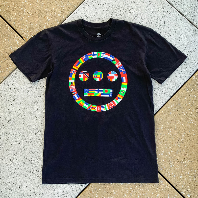 Black t-shirt with Hieroglyphics full-color international flag logo on cement.