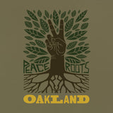 Close up on the t-shirt graphic with an oak tree, leaves, and a brown hand for a trunk with the words Peace, Roots, Oakland.