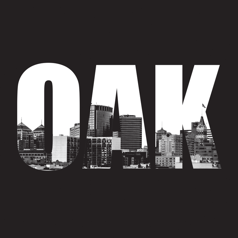 Close up of t-shirt graphic with capital letters spelling OAK, containing pictures of the Oakland skyline. 