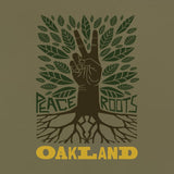 Close up of t-shirt graphic with an oak tree, green leaves, and a brown hand for a trunk with words Peace, Roots, Oakland.