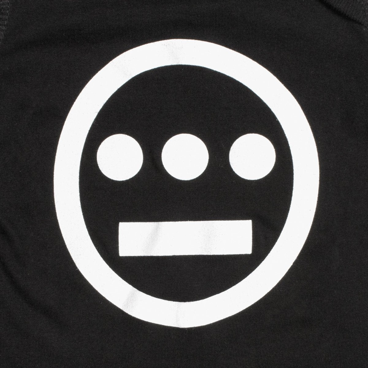 Close-up of large white Hiero hip-hop crew logo on a black infant one-piece.
