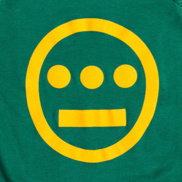 Close-up of large yellow Hiero hip-hop crew logo on a green infant one-piece.