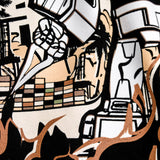 Detailed close-up of graphic of Kaiju vs. Autobart monsters invading Oakland on a black t-shirt laying on asphalt. 