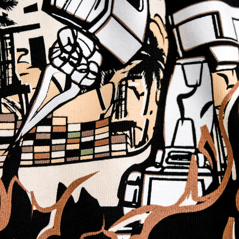 Detailed close-up of graphic of Kaiju vs. Autobart monsters invading Oakland on a black t-shirt laying on asphalt. 