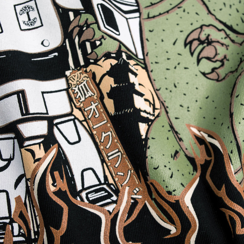 Detailed close-up of graphic of Kaiju vs. Autobart monsters invading Oakland on a black t-shirt laying on asphalt. 