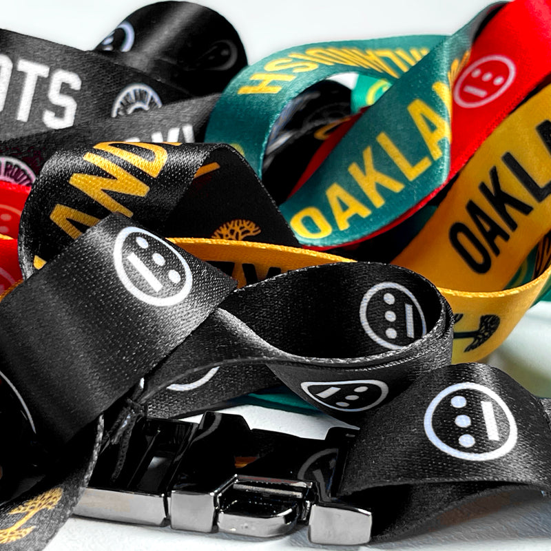 Detailed close-up of a jumble of red, yellow, black and green lanyards with Hiero hip-hop logos.