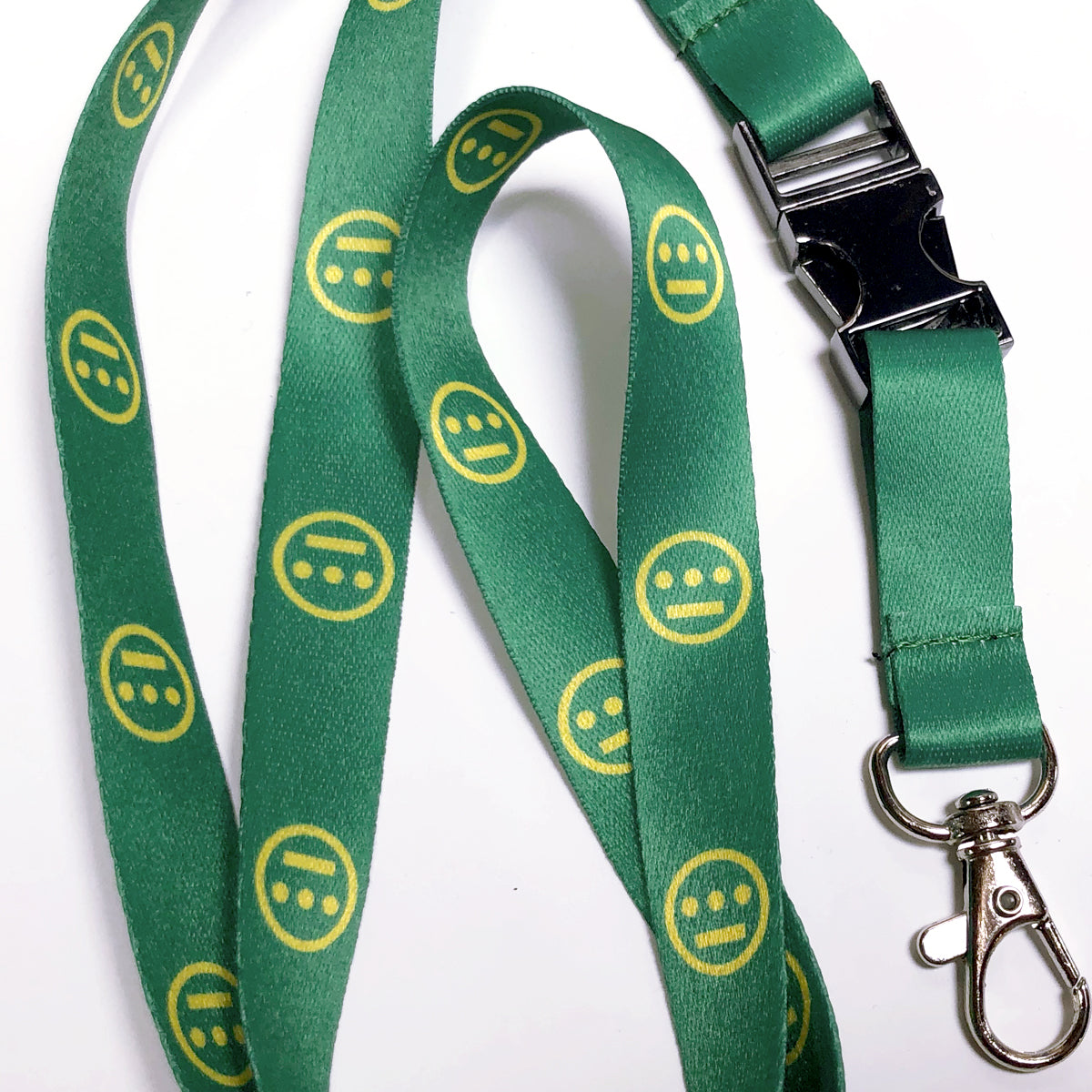 Detailed close-up of green quick release lanyard with yellow Hieroglyphics logo on repeat. 