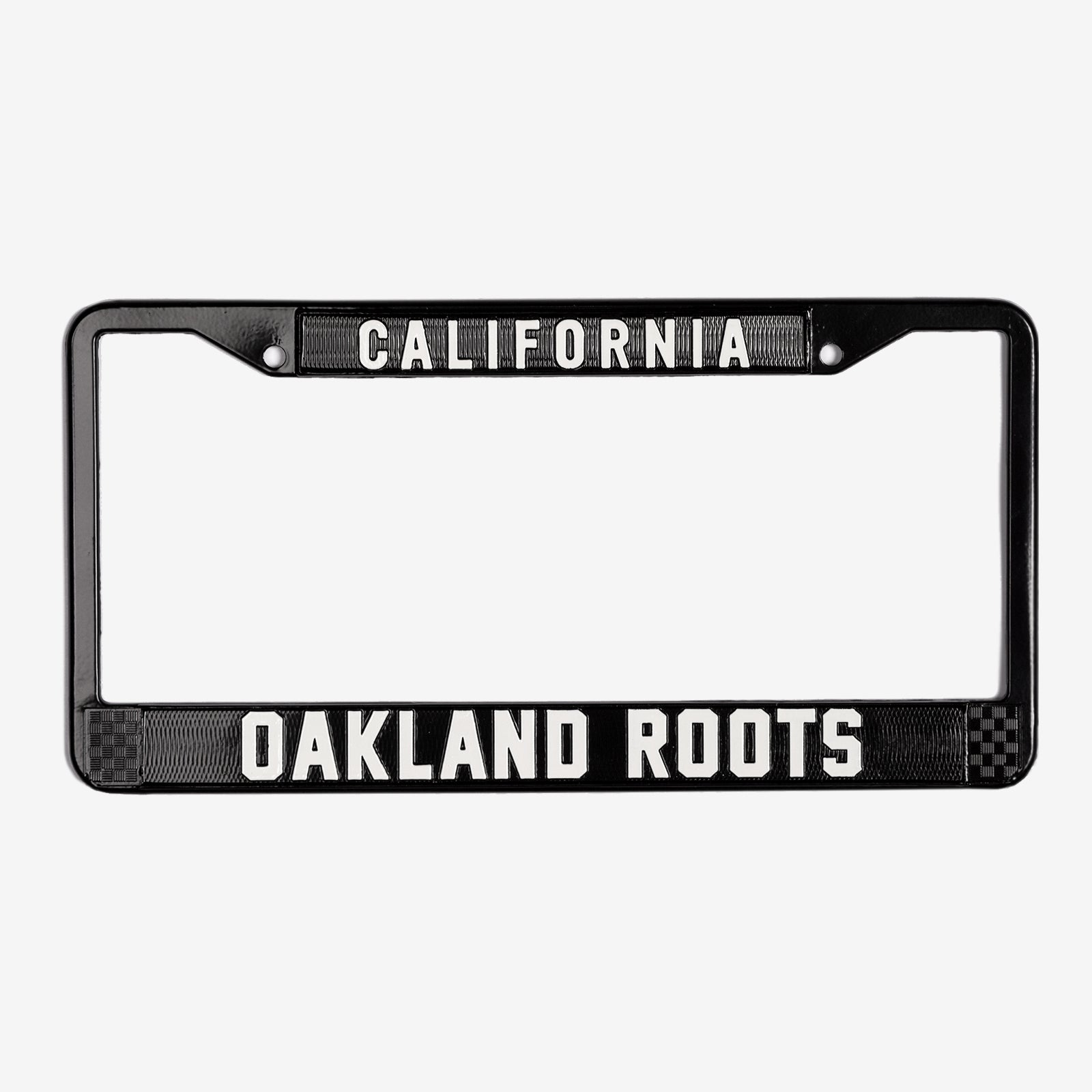 License plate holder with black rims with silver California wordmark on top and Oakland Roots logo on the bottom. 