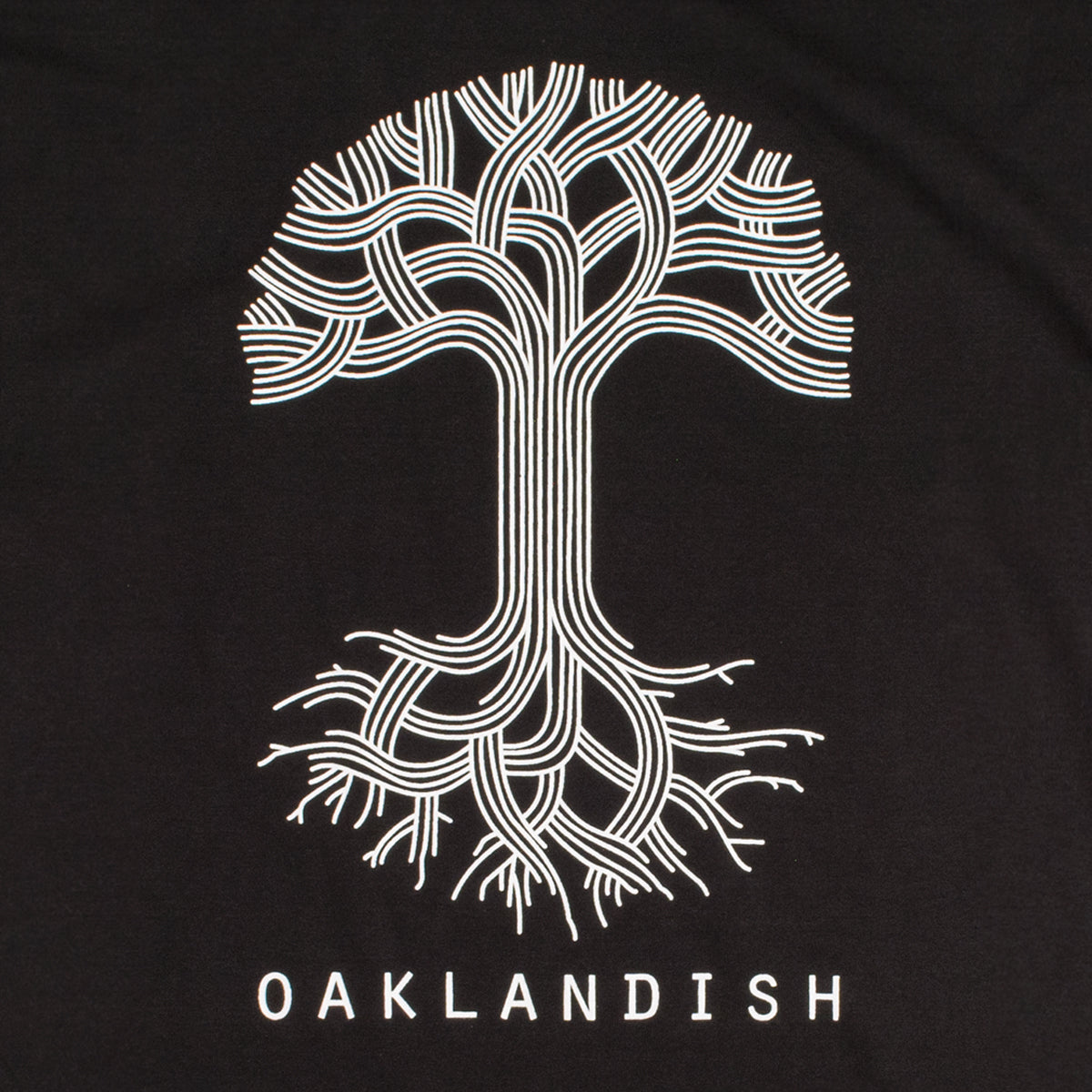 Close-up of a large white Oaklandish tree logo on the chest of a black t-shirt.
