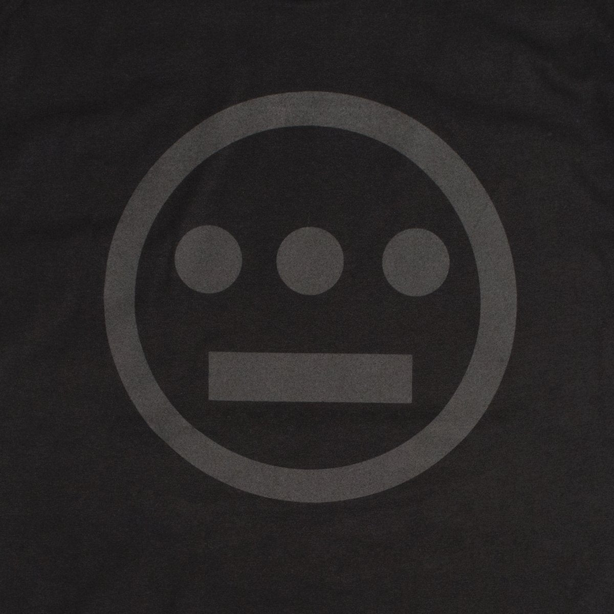 The Hiero Classic Logo Tee by Hieroglyphics features a minimalist grayscale design on a black background. The design consists of three small filled circles lined horizontally above a short, thick horizontal bar, all enclosed within a larger circle. The elements resemble modern hieroglyphics subtly shaded against the dark backdrop, making it perfect for a t-shirt.