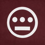 Close up of white Hieroglyphics Hip-Hop logo on a burgundy t-shirt.