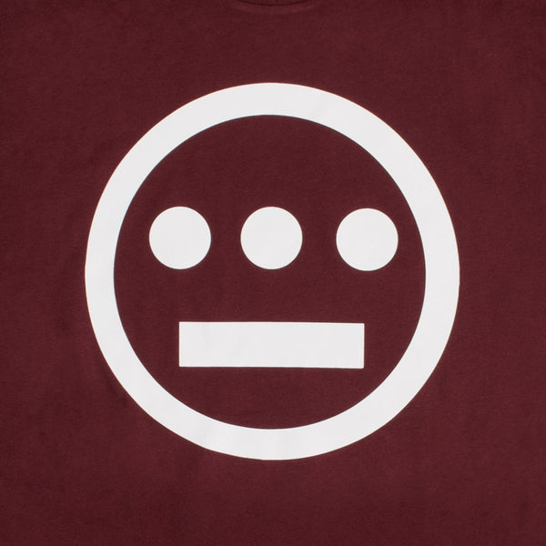 Close up of white Hieroglyphics Hip-Hop logo on a burgundy t-shirt.