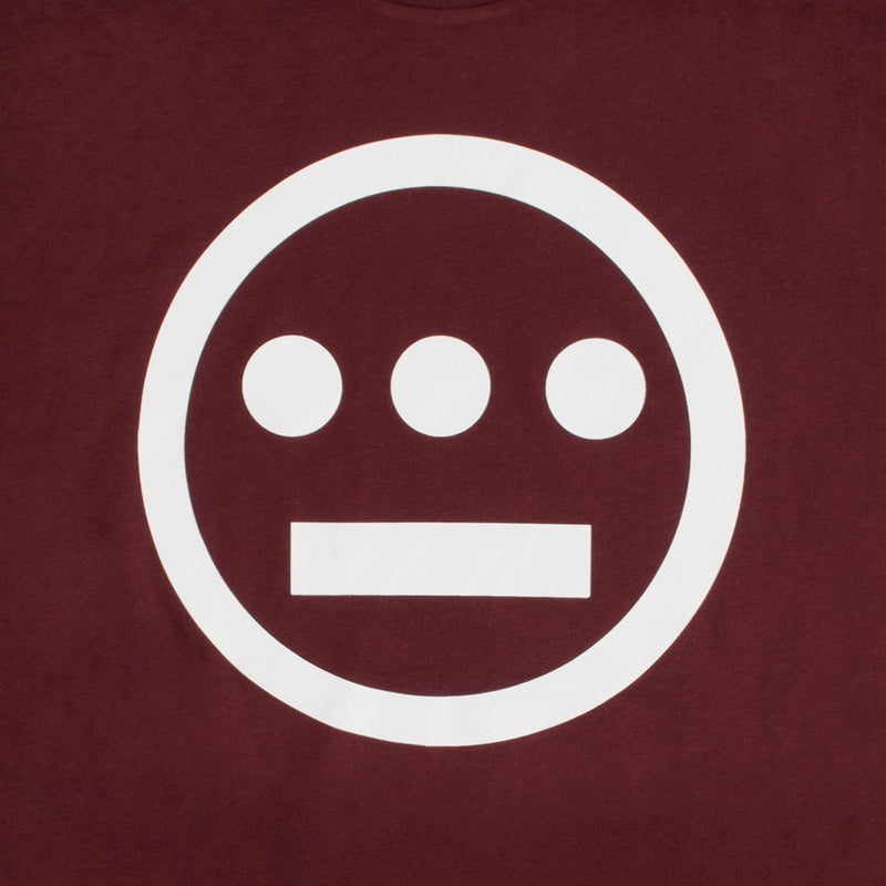 Close up of white Hieroglyphics Hip-Hop logo on a burgundy t-shirt.
