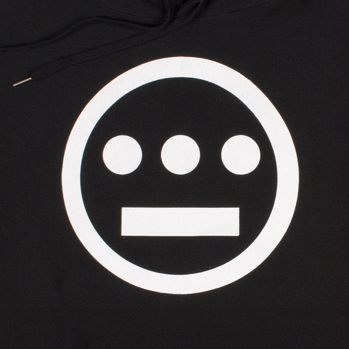 Close-up of white Hieroglyphics hip hop logo on the chest of a black hoodie.