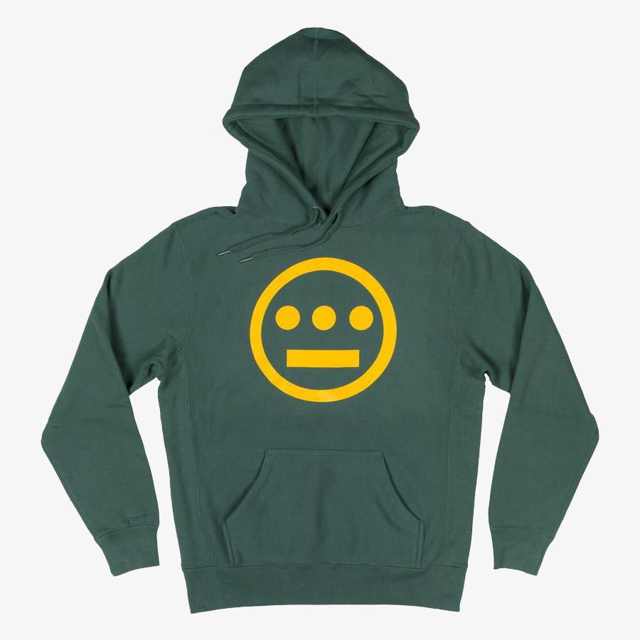 The Hiero Classic Logo Heavyweight Hoodie by Hieroglyphics features a green color with an iconic yellow circle logo that resembles a face, complete with three horizontal dots as eyes and a line below for a mouth. It includes drawstrings hanging down the front, has long sleeves, and comes with a front pocket. This hoodie is perfect for any hip hop crew looking to rock a stylish yet comfortable look.